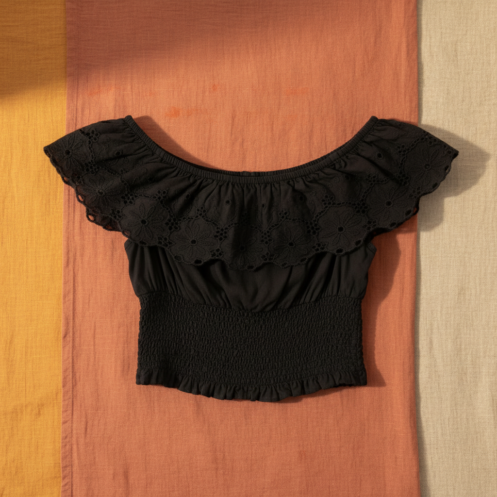Top broderie anglaise noir — fond chaleureux